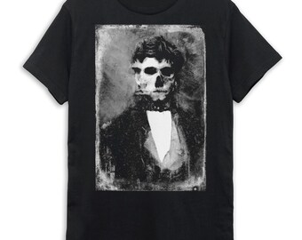 May include: Black t-shirt with a vintage-style image of a man with a skull face. The image is in black and white and has a distressed look.