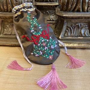 Regency Reticule made in an olive taffeta with a stunning floral embroidery design, ornate pink tassel, pink satin ribbon with pink tassels.