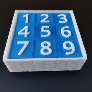 Corsi cubes. 9 blue plastic cubes with white embossed numbers