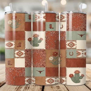 May include: Three stainless steel tumblers with lids and straws. The tumblers feature a patchwork design with western-themed images like boots, cacti, and bandanas. The color palette includes shades of brown, tan, and green, creating a rustic aesthetic.