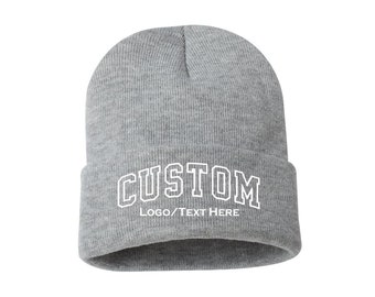 May include: Gray knitted beanie with a white custom logo that says "CUSTOM LOGO/TEXT HERE".