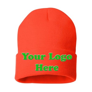 May include: A bright orange beanie with the text "Your Logo Here" in green.