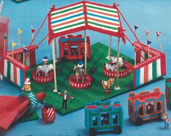 May include: A colourful plastic canvas craft set featuring a circus tent, animal cages, a carousel, and a clown. The set includes a variety of figures, including a zebra, a horse, a lion, and a clown. The set is perfect for children who love to play pretend.