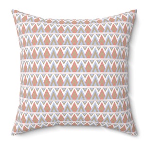 May include: A decorative throw pillow with a geometric pattern featuring a repeating design of triangles in shades of blue, pink, and brown.