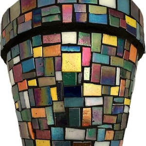 May include: A mosaic flower pot with a black rim and base. The pot is covered in a mosaic of colorful, iridescent tiles in shades of blue, green, yellow, orange, and pink. The tiles are rectangular and square.