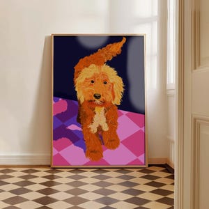 May include: A framed art print featuring a stylized illustration of a golden-colored dog. The dog is depicted against a dark blue background and a pink and purple checkered floor. The artwork is in a gold-colored frame.