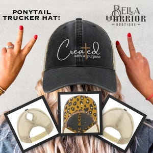 May include: Black and tan ponytail trucker hat with the text "Created with a purpose" and a cross graphic. The hat has a mesh back and a curved brim. The hat is displayed with three different views of the hat.