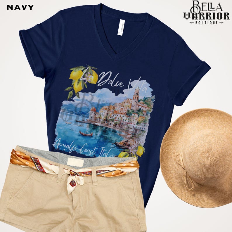 May include: Navy blue t-shirt featuring a watercolour illustration of a coastal Italian town with the text "Dolce Vita" and "Amalfi Coast, Italy".