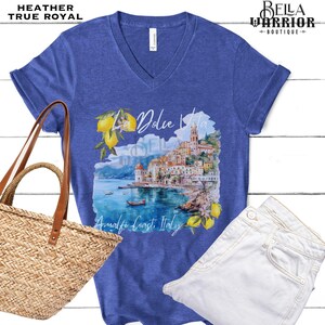 May include: A blue heather t-shirt with a watercolour design of a coastal Italian town with the text "La Dolce Vita Amalfi Coast, Italy".