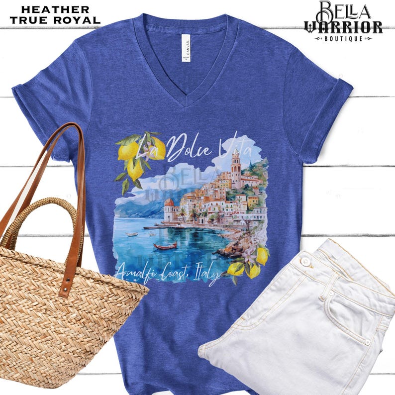 May include: A blue heather t-shirt with a watercolour design of a coastal Italian town with the text "La Dolce Vita Amalfi Coast, Italy".