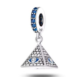 May include: Silver charm with a pyramid design. The pyramid has an eye on each side and is accented with blue enamel. The top ring is also adorned with blue stones. The charm is marked with "S925".