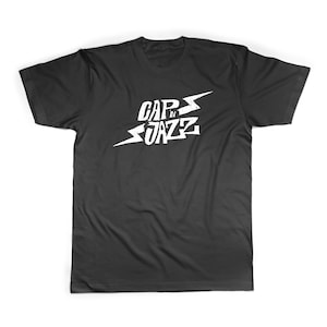 May include: Black t-shirt with a white graphic of a lightning bolt and the text "CAP'N JAZZ"