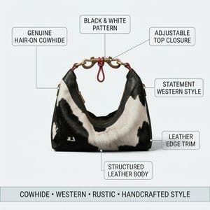 May include: A handbag featuring a black and white hair-on cowhide pattern, structured leather body, and leather edge trim. It includes an adjustable top closure with a red cord and brass hardware. Text labels include: GENUINE HAIR-ON COWHIDE, BLACK & WHITE PATTERN, ADJUSTABLE TOP CLOSURE, STATEMENT WESTERN STYLE, LEATHER EDGE TRIM, STRUCTURED LEATHER BODY, COWHIDE &bull; WESTERN &bull; RUSTIC &bull; HANDCRAFTED STYLE.