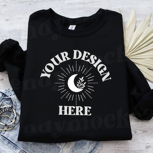 May include: Black sweatshirt with a white crescent moon and star design. The text "YOUR DESIGN HERE" is printed on the front of the sweatshirt.