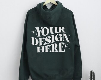 May include: A dark green hooded sweatshirt with the text "YOUR DESIGN HERE" printed on the back in white.