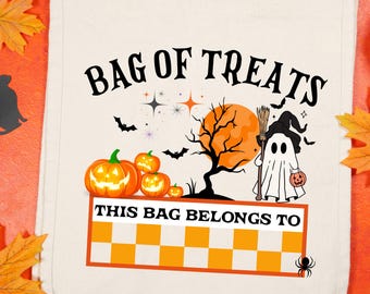 May include: Off-white canvas tote bag with the words "BAG OF TREATS" in black. The bag features Halloween-themed graphics, including pumpkins, bats, a ghost, and the text "THIS BAG BELONGS TO".