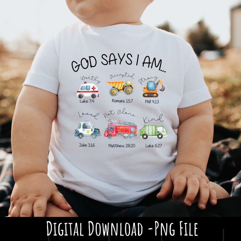 May include: A white t-shirt featuring a design of construction vehicles and bible verses. The text reads "God says I am..." and includes verses such as "Luke 7:4", "Romans 15:7", and "Phil 4:13".