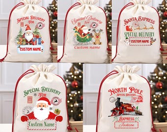 May include: Five beige Santa sacks with red drawstrings. Each sack features a different Christmas-themed design, including Santa Claus, reindeer, and a train. Text includes "Special Delivery," "Santa Express," and "North Pole."