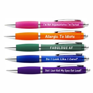 May include: Five ballpoint pens in various colours: pink, orange, green, blue, and purple. Each pen features a different humorous phrase: "I'm Not Argumentative I'm Factual", "Allergic To Idiots", "FABULOUS AF", "Do I Look Like I Care?", and "Did I Just Roll My Eyes Out Loud?"