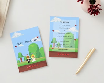May include: A wedding invitation with a pixelated video game theme. The invitation features a couple in pixelated form standing in front of a green background with trees. The text "We're Leveling Up!" is at the top of the invitation. The invitation also includes the text "Together" and the names "Emily Williams & Benjamin Smith".
