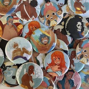 May include: A collection of colorful round buttons featuring various anime characters. The buttons showcase characters with diverse skin tones, hair colors, and expressions. The artwork style is vibrant and detailed, with a cartoonish aesthetic.