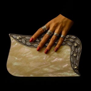 Luxury mother of pearl clutch with silver leaf detailing and pearl accents