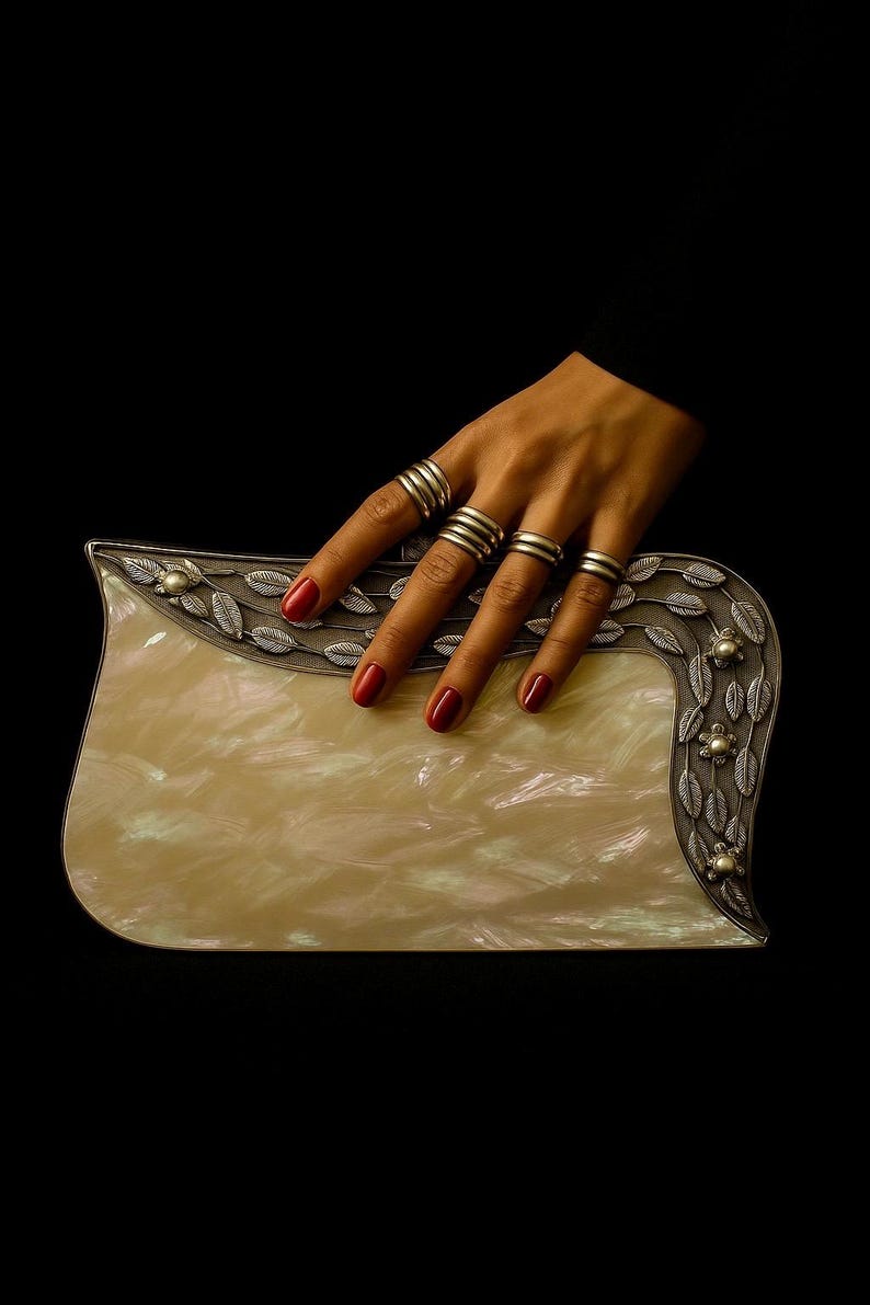 Luxury mother of pearl clutch with silver leaf detailing and pearl accents