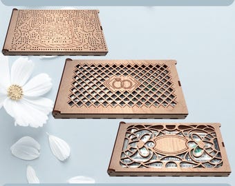 May include: Three laser-cut wooden money holders with intricate designs. One features a cake, another interlocking rings, and the third an ornate floral pattern. The text "MONEY HOLDER LASER CUT" and "CDR SVG EPS PNG PDF DXF" are displayed.