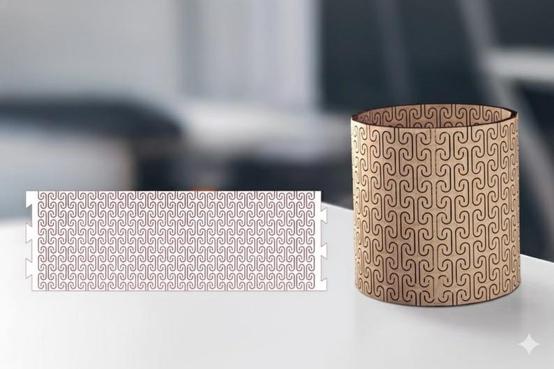 May include: A cylindrical wooden container with a repeating pattern of curved lines. Beside it, a flat, rectangular piece with the same pattern. Both items are light brown with dark brown detailing, set against a blurred background.