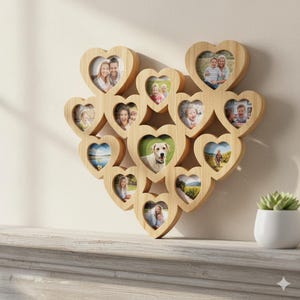 May include: Wooden heart-shaped photo collage frame with multiple openings. The frame is filled with various photos of people and a dog. The frame is made of light-colored wood and is displayed on a white surface.