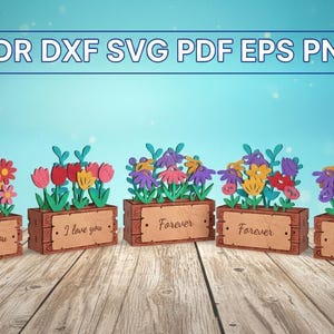 Puede incluir: Cinco cajas de flores de madera con flores de papel de colores. Cada caja tiene un letrero de madera con un mensaje: "I love you", "Forever" y "Thank you". La imagen también incluye el texto "CDR DXF SVG PDF EPS PNG".