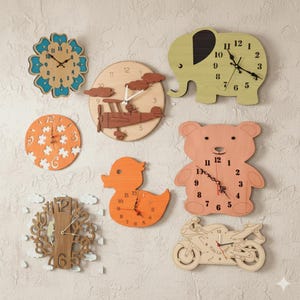 May include: A selection of wooden clocks in diverse forms, such as a flower, aeroplane, elephant, puzzle, duck, bear, tree, and motorcycle. Each clock features black hands and numerals, with a natural wood or painted finish. These clocks are designed for wall mounting.