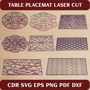 May include: Laser-cut table placemats in various geometric and floral designs. The placemats are in shades of purple and are displayed on a light wood surface. The text "TABLE PLACEMAT LASER CUT" and file type options are visible.