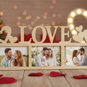 May include: A wooden photo frame with the word "LOVE" cut out, holding three pictures of couples. The frame has heart-shaped cutouts and is decorated with red rose petals. A lit-up heart shape is in the background.