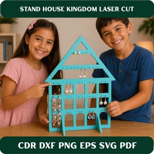 May include: A turquoise laser-cut wooden jewelry stand shaped like a house with a triangular roof and multiple rectangular openings. The stand features numerous small holes for hanging earrings and necklaces, displaying various dangling jewelry pieces.