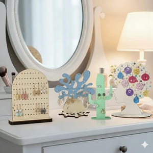 May include: A collection of decorative earring holders in various shapes and colors. Includes a wooden pegboard, a blue coral design, a green cactus, and a white silhouette with colorful hanging earrings. The holders are displayed on a white surface.
