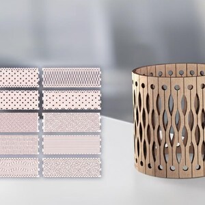 May include: A cylindrical wooden candle holder with an openwork design of elongated ovals and small circles. To the left are rectangular tiles with various patterns in pink and brown, including hearts, dots, and geometric shapes. The candle holder is approximately 15 cm tall.