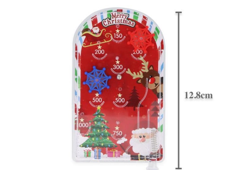 May include: A festive Christmas pinball game with a red backdrop and seasonal illustrations. The game features a Christmas tree, Santa Claus, reindeer, and snowflakes. The game is 12.8 cm tall.
