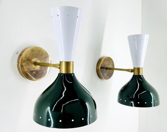 May include: A pair of brass and metal wall sconces with white and green shades. The shades have a dotted pattern.