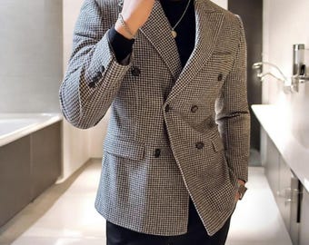 May include: A double-breasted blazer in a black and white checkered pattern. The blazer has a notched lapel, two front pockets, and a breast pocket. The sleeves have buttoned cuffs. The brand name "Kkwear" is visible in the top left corner.