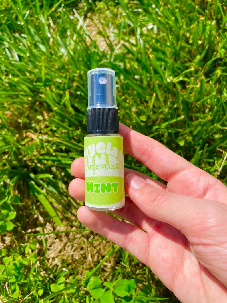 May include: A small clear plastic bottle with a black spray nozzle and a green and white label that says "Mycla  Mouth Spray  Mint".