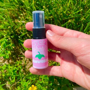 May include: A small pink and green spray bottle with a clear cap. The bottle has the words "Mycelia" and "Strawberry" printed on it.