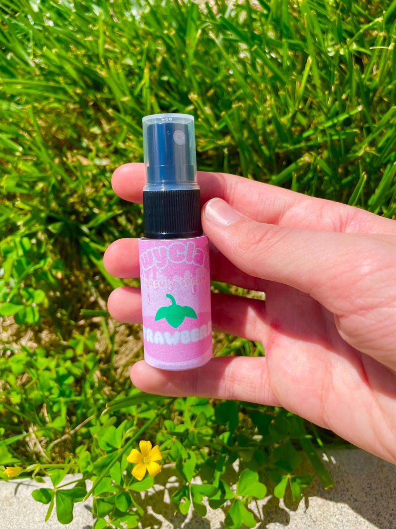 May include: A small pink and green spray bottle with a clear cap. The bottle has the words "Mycelia" and "Strawberry" printed on it.