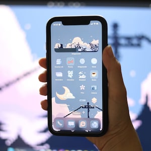 May include: A smartphone with a blue and white background and a variety of app icons. The icons are arranged in a grid pattern and include apps such as "Clock", "Photos", "Reminders", "Calculator", "Books", "Camera", and "Files".