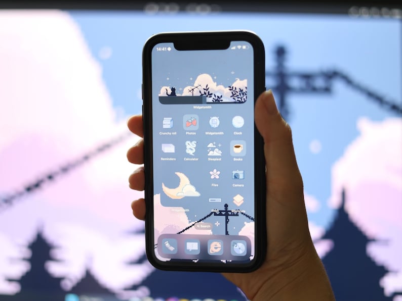 May include: A smartphone with a blue and white background and a variety of app icons. The icons are arranged in a grid pattern and include apps such as "Clock", "Photos", "Reminders", "Calculator", "Books", "Camera", and "Files".