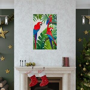 May include: Three red and blue macaws perched on tropical green leaves. The macaws are facing different directions. The background is white.