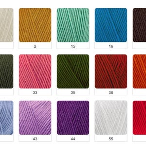 May include: A white ceramic mug with a black handle and the text "But First, Coffee" in a bold, black font. The mug is set against a blurred background, suggesting a cozy setting.