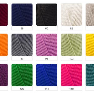 May include: A collection of yarn skeins in various colors, including burgundy, navy blue, black, cream, and tan. Other colors include orange, gray, purple, green, and yellow. Each skein is labeled with a number.