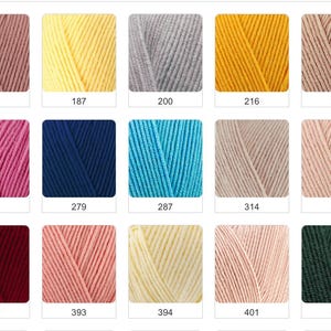 May include: A collection of yarn skeins in various colors, including pink, yellow, blue, and green. Each skein is labeled with a number. The yarn appears to be soft and suitable for knitting or crocheting projects.