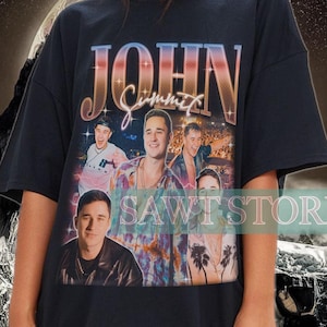 May include: Black oversized t-shirt with a graphic print of a band called "John Summit". The print features a collage of band members with a colorful background.